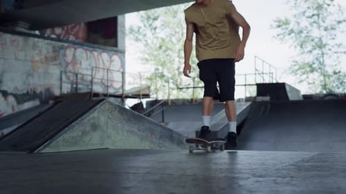 Extreme Casual Man Riding on Skate Board Outdoors. Close Up Male Teenager