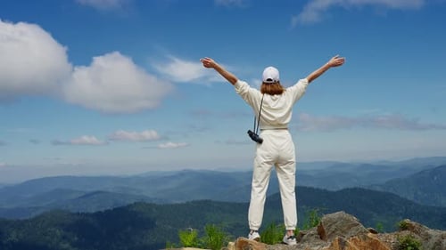 Woman Embraces Freedom on Mountaintop