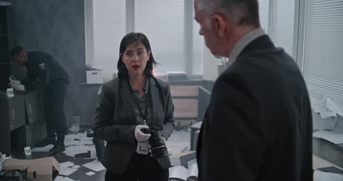 Office Robbery Case Female Criminalist Talks to Male Detective Then Takes Photos of Evidence