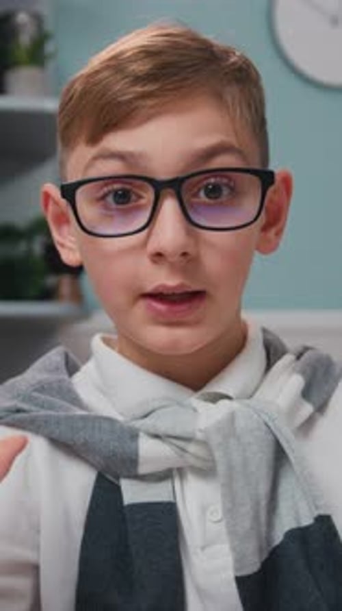 Smiling Boy Talking and Looking Into Camera Indoors