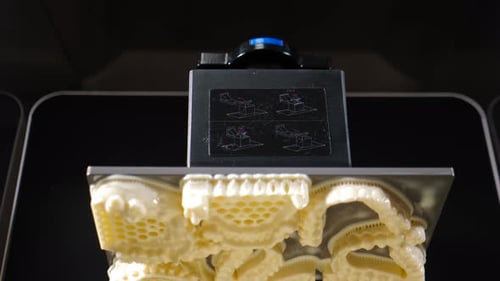 Advancements in Dental Technology Highlight a Cutting Edge 3d Printer Producing Dental Prostheses