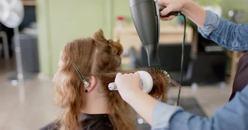 Stylist Blow Drying Customer's Wavy Hair at Salon