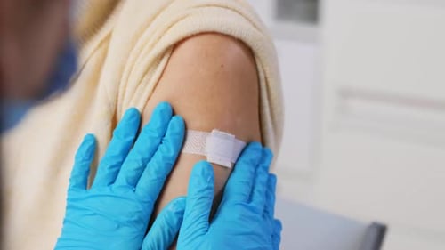 Adult Receives Vaccine Injection in Upper Arm