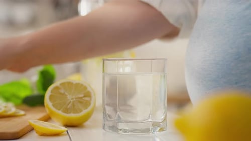 Fresh Lemon Slice Added to Refreshing Water