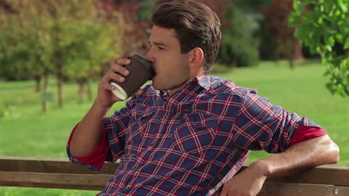 Male On Park Bench With Coffee