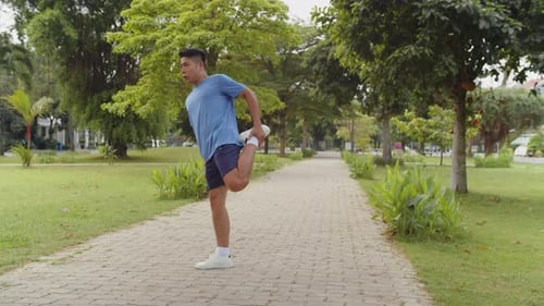 Asian Sportsman Working Out in Local Park