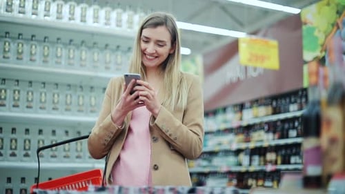 Beautiful Young Woman Use Phone in Supermarket Smartphone Buyer Communication Store Cellphone