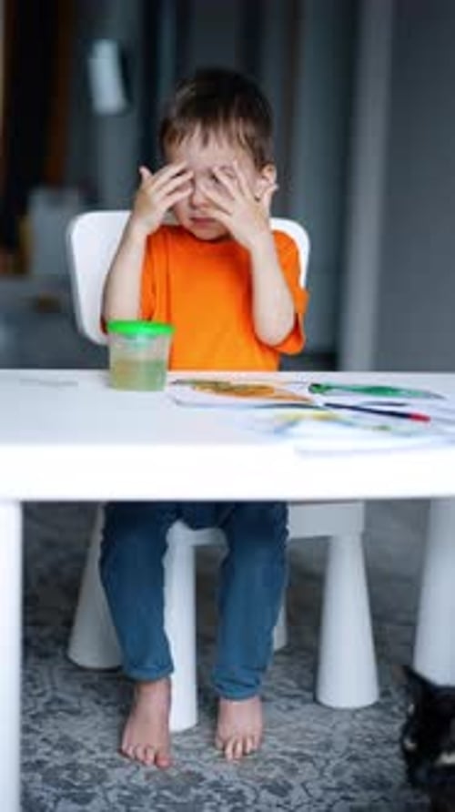 Child Drawing at Table in Home