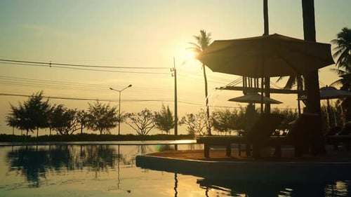 umbrella with bed pool around swimming pool with ocean sea background - holiday and vacation concept