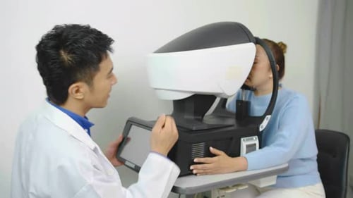 Asian optician doctor working with eye vision measurement machine, Eye exam for senior woman