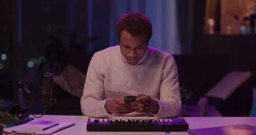 A Young Artist Creating Original Music in a Cozy Home Studio Environment with Passion