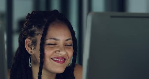 4k video of a young designer working late on a computer in an office