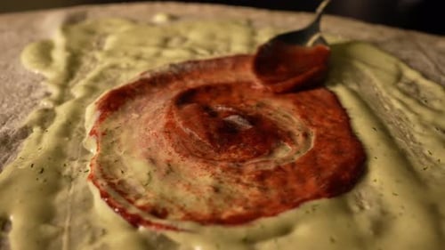 Spreading Red Sauce Over Pizza Base