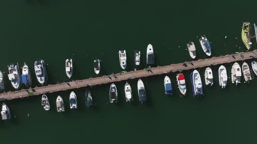Boats and small sailing Yachts docked in a beautiful marina, Top down view