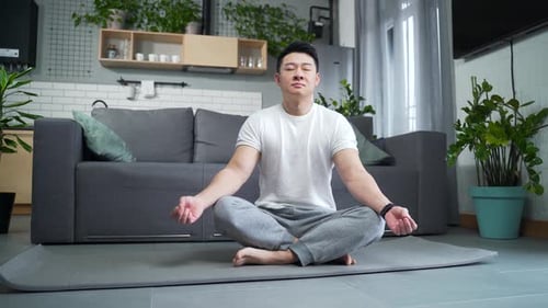 Young Adult Meditating Calmly at Home