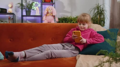 Girl Relaxing on Couch Playing with Smartphone