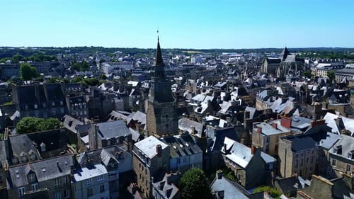 Clock tower or the Tour de l'Horloge and Saint-Malo church in background, Dinan, France. Aerial dron