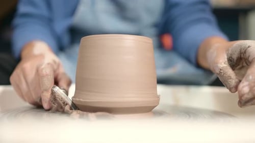 Craftsperson Shapes Clay on Pottery Wheel