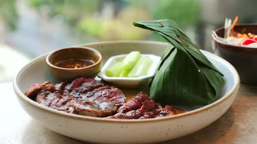 Exquisite Grilled Meat Dish with Banana Leaf Presentation