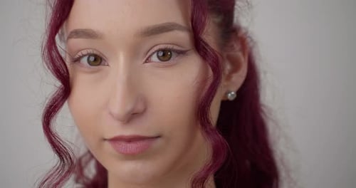 Macro close up gimbal shot of beautiful woman face looking at camera