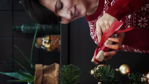 Woman Prepares Christmas Gift with Festive Joy
