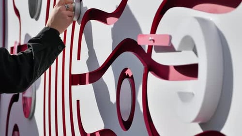 Hand Interacting with an Abstract Puzzle Wall