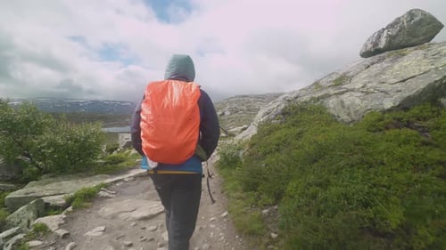 guy travels on a beautiful mountain road in norway