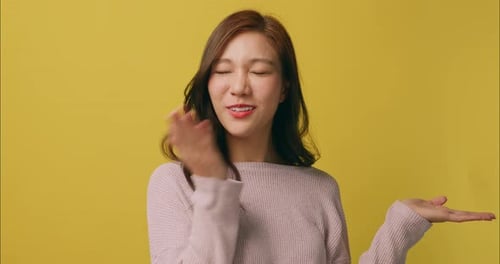 Smiling Woman Posing on Yellow Background