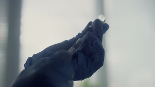 Medical nurse hands preparing covid 19 vaccine dose for patient injection