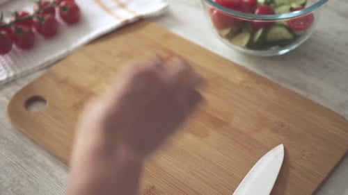 Chopping Cherry Tomatoes on a Cutting Board