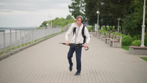 Joyful City Dance Man Enjoying Lively Dance Under Rainy Sky with Headphones Spontaneous City Dweller