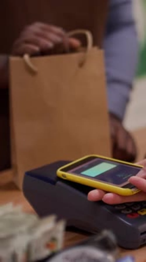 Making Mobile Payment With Yellow Cell Phone