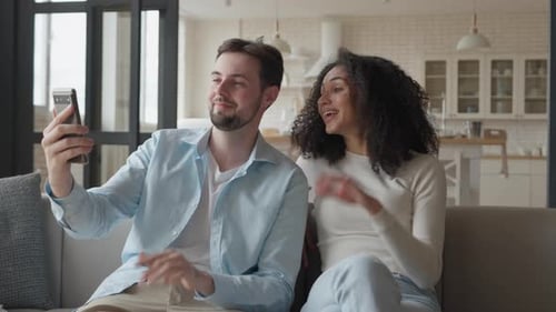 Happy Couple Make Video Call Mobile Phone View Looking at Camera Wave Hands