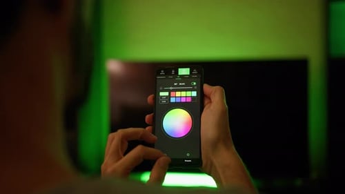 Man Using App to Control Color of Lights