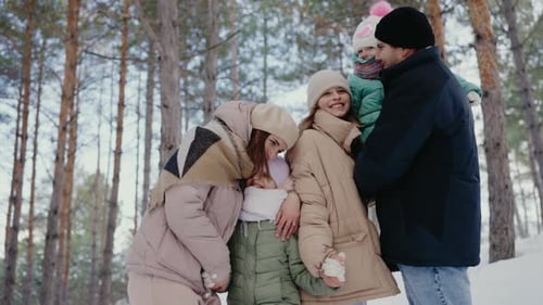 Happy Family Enjoying a Winter Day Together in the Snow