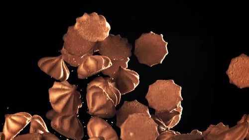 Cookies Falling Against Black Background