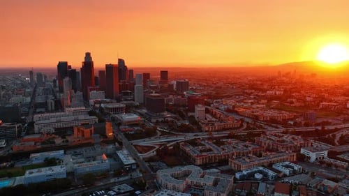 Soft orange light coating the panorama of Los Angeles, California, USA.