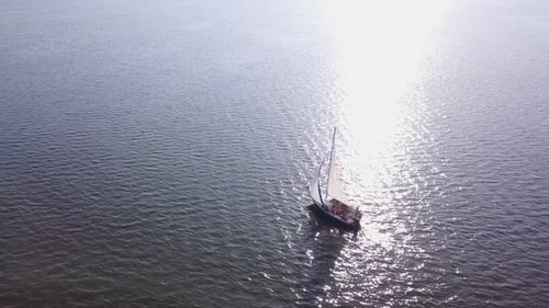 Kleines Segelboot im ruhigen Meerwasser, Luftaufnahme
