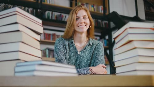 Portrait of Young Woman Student or Businesswoman in the Library Students in a Good Mood Studying and