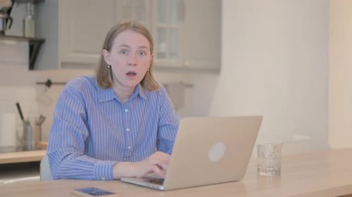 Woman Receiving Shocking News on Laptop Computer