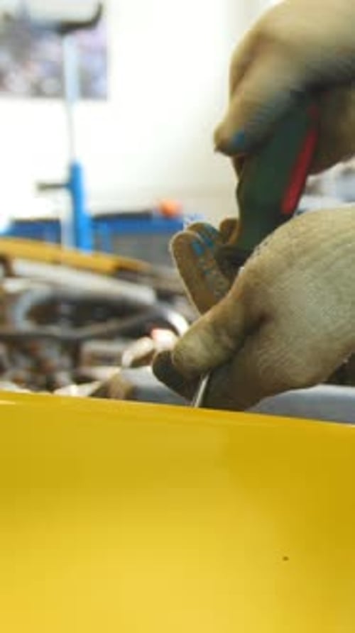 Mechanic Unscrews Detail of Car in Hood Automobile Service Repairing