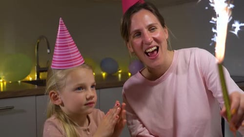 Woman and Child Celebrating Birthday with Sparkler