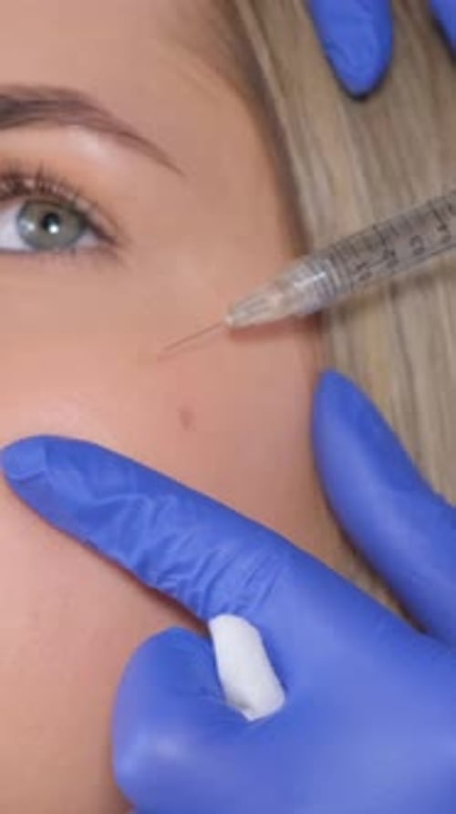 Close-Up Injection Into Young Person's Face