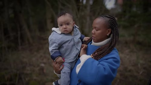 Mother Holding Young Baby Child Boy Outside Enjoying Family Life