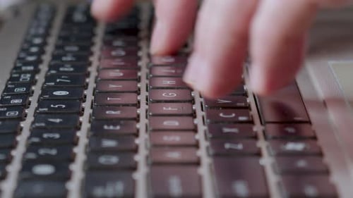 Woman's Finger Typing On Laptop Keyboard. - close up