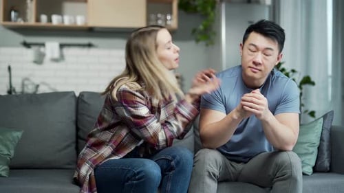 Young Couple Having a Serious Conversation on Couch