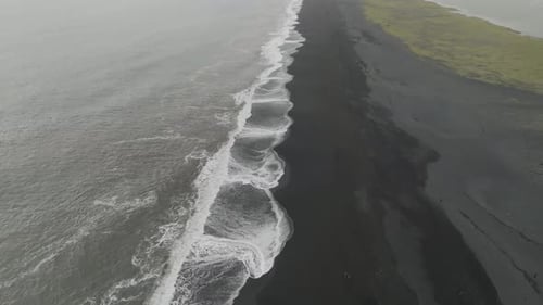 Aerial view of black sand beach in Iceland in winter.