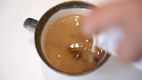 Putting milk in filter coffee close up 4K