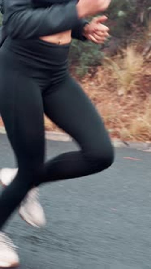 Woman, legs and running with shoes on road for cardio exercise, workout or outdoor training