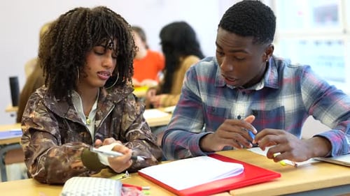 University Students Collaborating on Project in Classroom